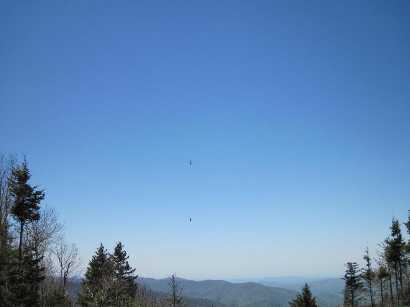 Helicopter carries the Locust logs to their destination - Great Smoky Mountains