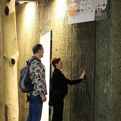 Woman feels the ultimate texture of Bark House Poplar Bark Panel Sheets