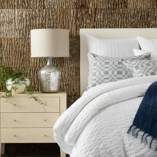 Annie Selke, Pine Cone Hill, uses Bark House Poplar Bark interior shingles for a beautiful backdrop to her linens: white bedspread