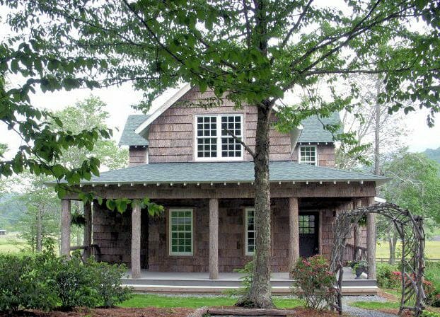 Sweet house with exterior bark siding and bark intact poles for columns 