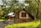 How to bring the family legacy of an old cabin home into a new one? Carry over key features of the old and wrap it up in bark siding to keep nature close.