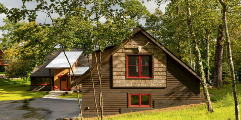 How to bring the family legacy of an old cabin home into a new one? Carry over key features of the old and wrap it up in bark siding to keep nature close.